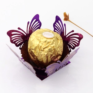 Close-up of laser-cut purple butterfly favor box with a chocolate inside for weddings