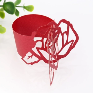 Detailed laser-cut red paper napkin ring with 3D rose flower design for wedding decor