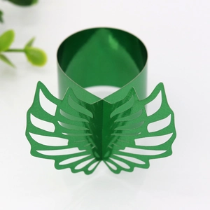 Detail of laser-cut green monstera leaf paper napkin rings for tropical party decor