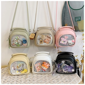 Detail of multi-color crossbody Ita bags featuring transparent windows for DIY decorations