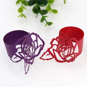 Detail of laser-cut rose hollow napkin rings in purple and red cardstock