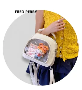 Close-up of a white PU leather ita bag with a clear window and adjustable straps