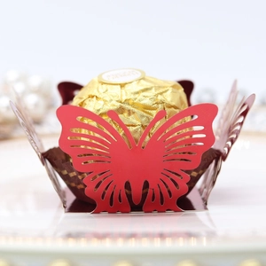 Detail of red hollow butterfly chocolate paper holder for elegant wedding parties