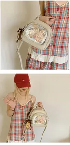 Detail of cream white Ita bag with transparent PVC window and customizable pins