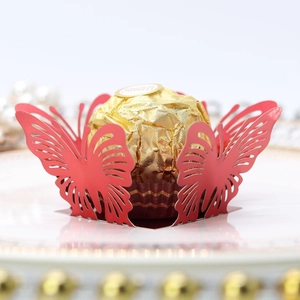 Detail view of a laser-cut red butterfly chocolate base for wedding party favors