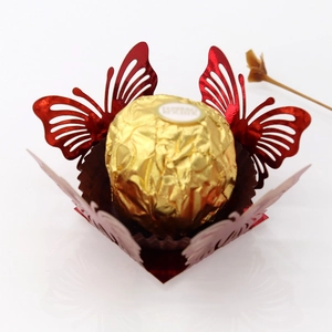 Detail of red hollow butterfly chocolate wrapper made of shiny pearlescent paper laser cut