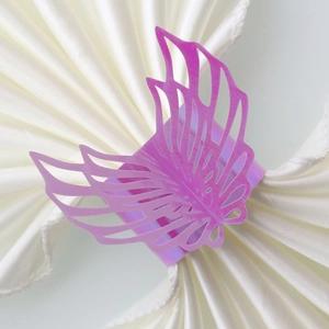 Detail view of laser-cut purple butterfly napkin ring with hollowed wing patterns