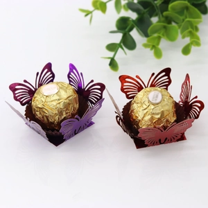 Detail of laser-cut hollow butterfly chocolate wrappers in purple and red metallic paper