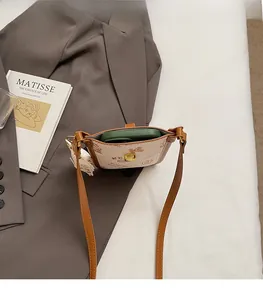 Detail of vintage monogram phone bag showing interior capacity with a smartphone inside