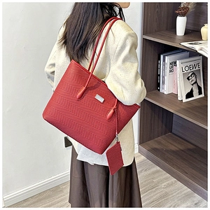 Detail of red chevron-pattern tote bag with matching coin purse on a shoulder strap