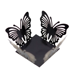 Macro detail of laser-cut black hollow butterfly candy box with delicate wing patterns