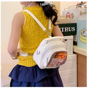 Detailed back view of a white PU leather ita bag with a clear window and plush doll