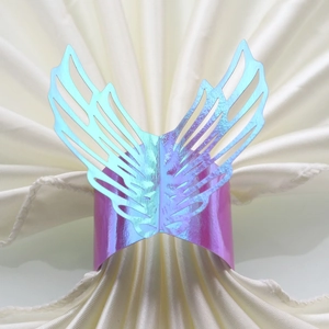 Macro detail of iridescent purple butterfly napkin ring with laser cut hollow design