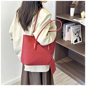 Detailed close-up of a red chevron pattern tote bag with a matching detachable pouch set