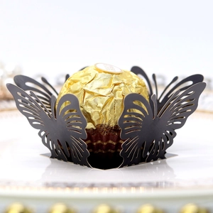 Detail of laser-cut black butterfly paper lace for chocolate and wedding party favors