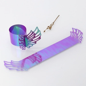 Detailed view of iridescent laser-cut angel wing paper napkin rings with metallic finish