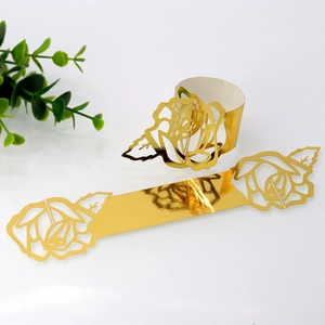 Macro detail of laser-cut golden rose napkin ring for wedding table decoration