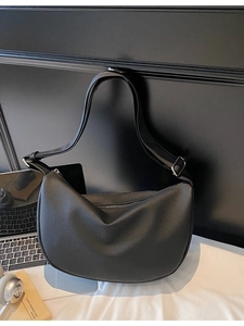Modern black pebble grain leather crescent shoulder bag with minimalist silver hardware