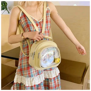 Detail of light yellow leatherita ita bag with a large clear window for hobby accessories