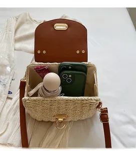 Detailed interior view of a woven crossbody bag with spacious storage and metal lock
