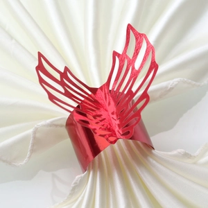 Detailed view of red hollow butterfly wing paper napkin ring on white silk cloth