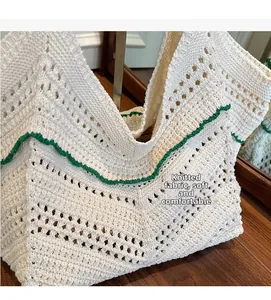 Close-up of soft knitted fabric detail with green wavy edge on beige woven tote bag