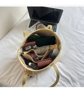 Interior view showing the large capacity and multiple compartments of the yellow tote bag