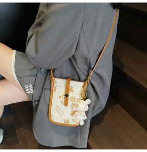 Chic white leather crossbody phone bag with teddy bear print and brown shoulder strap