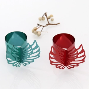 Detailed view of hollow leaf napkin rings in metallic green and red finishes