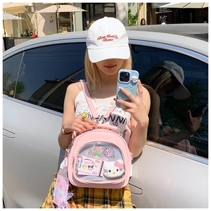 Pink Ita-bag detail showing a transparent PVC window with cute plush toy decorations