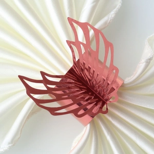 Close-up of rose gold butterfly napkin ring with laser-cut hollow wing details