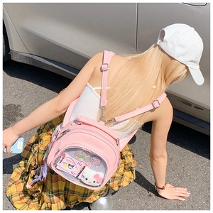 Outdoor shot of a pink Ita Bag with transparent PVC window for decorative items
