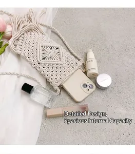 Detail of handmade cream woven phone bag with elegant diamond patterns and decorative tassels