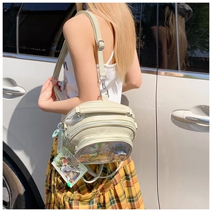 Close-up detail of the cream faux leather itabag with transparent window and zipper