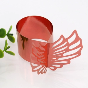 Detail of red hollowed-out butterfly napkin ring with metallic mirror finish