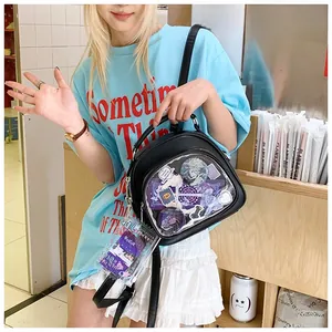 Close-up of a black Ita Bag with clear PVC window showing anime character charms
