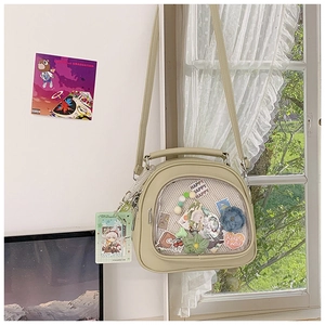 Detail of light green ITA bag with transparent DIY window and floral embroidery accents
