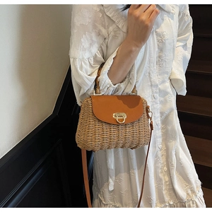 Close-up of retro woven straw crossbody bag featuring bamboo handle and leather flap