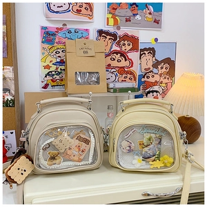 Detail view of Japanese style ita bags with transparent windows for anime pins and charms