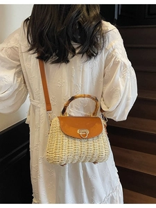 Woven straw crossbody bag with bamboo handle and leather flap for beach vacation