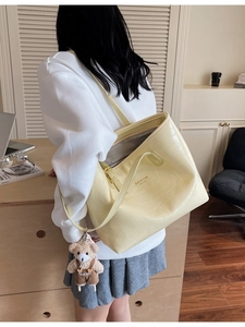 Pale yellow crocodile textured tote bag with bear charm and large capacity for women