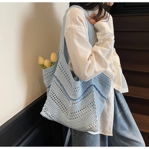 Macro shot of light blue woven tote bag showing Z-shaped hollow patterns and dark blue stitching