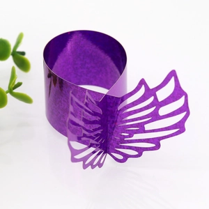 Detail of purple laser-cut paper napkin rings with hollow butterfly design and glitter finish