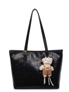 Fashionable black faux leather tote bag with crocodile embossing and plush bear charm