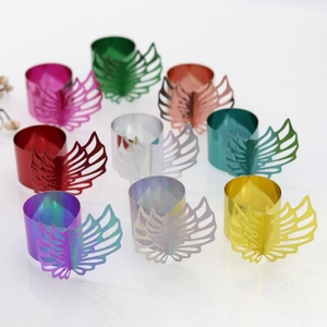Collection of laser cut wing napkin rings in various shiny metallic colors for wedding decor