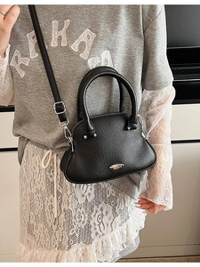 Elegant black lychee grain shell bag with stylish top handle and adjustable strap