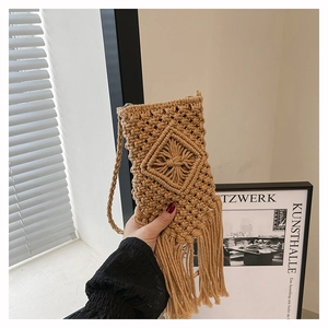 Detail of handmade khaki macramé phone bag with diamond patterns and long tassels