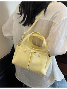 Minimalist large pale yellow faux leather tote bag with dual front flap pockets