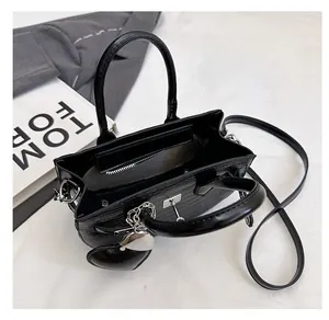 Internal view of black crocodile pattern handbag showing zip pocket and spacious compartment