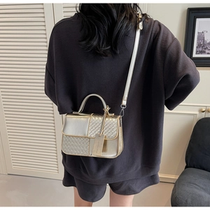 Detail of woven texture and metallic finish on a silver mini crossbody bag for women